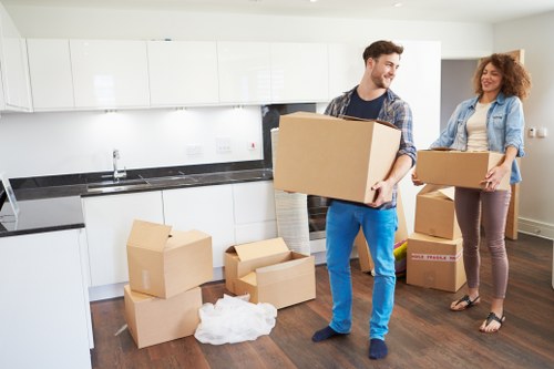 Organised unpacking boxes in a Hackney flat after a move