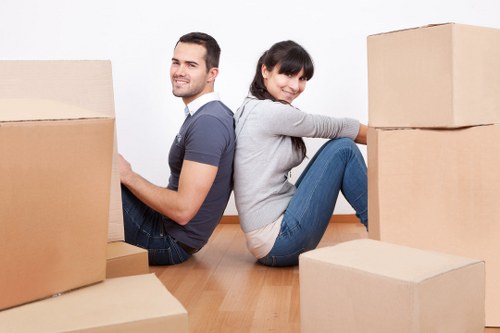 Helper carrying furniture for a flat move in Hackney