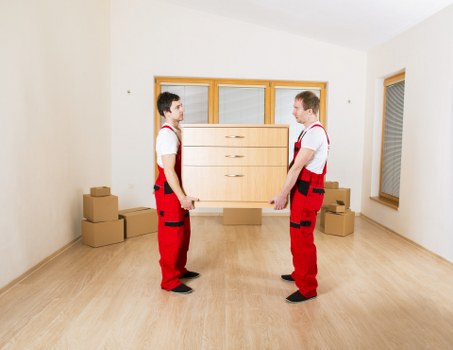 Local furniture pick-up van loading household items in Hackney